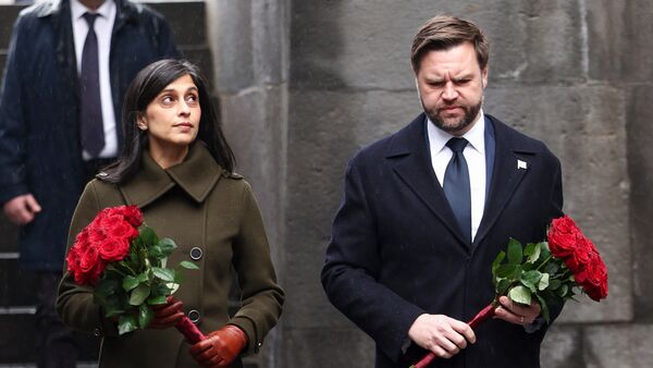 US Vice President JD Vance and second lady Usha Vance hold flowers as they walk towards the eternal flame at the Tsitsernakaberd Armenian Genocide Memorial in Yerevan, Armenia Tuesday, Feb. 10, 2026. (Pool Photo via AP)