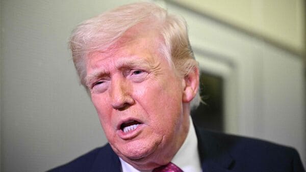 Donald Trump speaks to reporters aboard Air Force One en route to Joint Base Andrews, Maryland, on March 29, 2026 (Photo by AFP)
