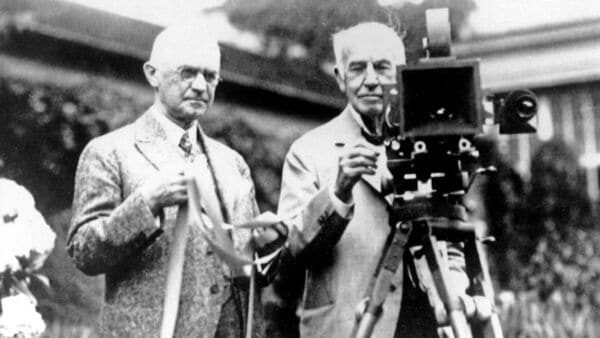 Eastman Kodak Co. founder George Eastman, left, and Thomas Edison pose with their inventions in a photograph taken in the late 1920s. Their contributions, Edison invented motion picture equipment and Kodak invented roll-film and the camera box, helped create the motion picture industry.