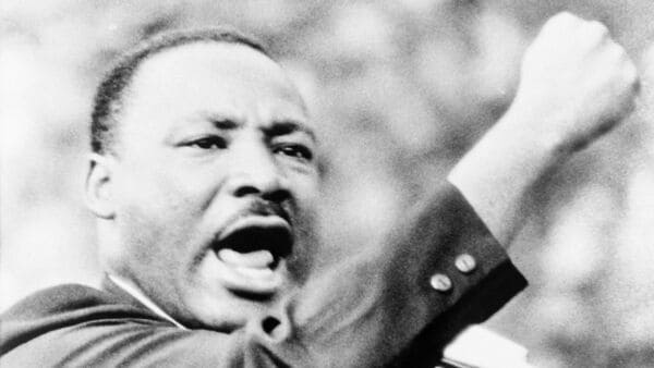 Martin Luther King, Jr., gesturing with right fist while delivering speech at Girard College, Philadelphia, on Aug. 3 1965.