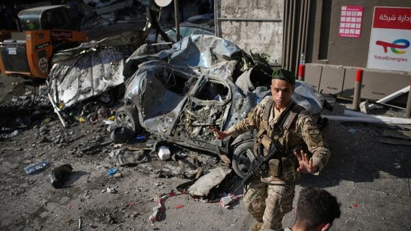 A Lebanese army soldier prevents people from approaching the site of an earlier Israeli airstrike in Beirut, Lebanon, Wednesday, April 8, 2026. (AP Photo/Emilio Morenatti)
