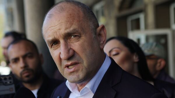 Former Bulgarian President Rumen Radev speaks to journalists after casting his vote at a polling station in Sofia, Bulgaria, Sunday, April 19, 2026, during early parliamentary elections.
