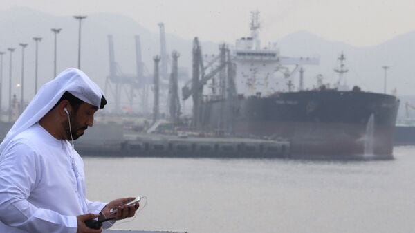 (FILES) An Emirati man stands at the oil terminal of Fujairah during the inauguration ceremony of a dock for supertankers on September 21, 2016. The United Arab Emirates will withdraw from the OPEC and OPEC+ oil cartels on May 1, 2026 state media said on April 28, 2026, calling it a strategic decision by the major producer. (Photo by Karim SAHIB / AFP)