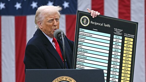 (FILES) US President Donald Trump holds a chart as he delivers remarks on reciprocal tariffs during an event in the Rose Garden entitled Make America Wealthy Again at the White House in Washington, DC, on April 2, 2025. (Photo by Brendan SMIALOWSKI / AFP)