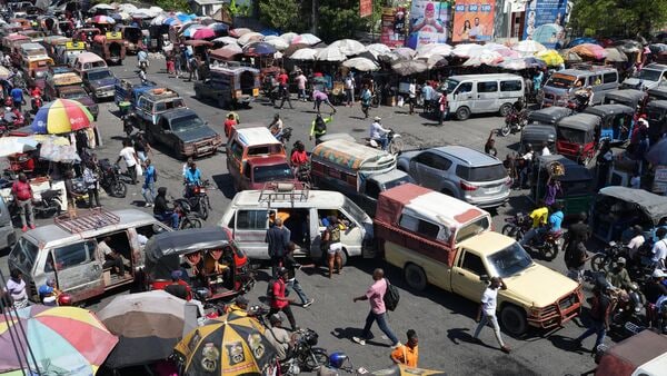 Vehicles crowd an intersection in the Delmas neighborhood of Port-au-Prince, Haiti, Friday, April 10, 2026. (AP Photo/Odelyn Joseph)