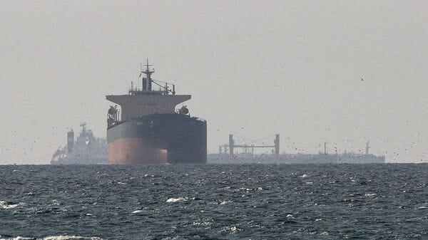 FILE PHOTO: Cargo ships in the Gulf, near the Strait of Hormuz, as seen from northern Ras al-Khaimah, near the border with Oman’s Musandam governance, amid the U.S.-Israeli conflict with Iran, in United Arab Emirates, March 11, 2026. REUTERS/Stringer/File Photo
