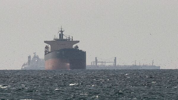 FILE PHOTO: Cargo ships in the Gulf, near the Strait of Hormuz, as seen from northern Ras al-Khaimah, near the border with Oman’s Musandam governance, amid the U.S.-Israeli conflict with Iran, in United Arab Emirates, March 11, 2026. REUTERS/Stringer/File Photo