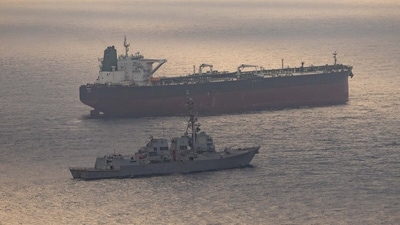 USS Rafael Peralta (DDG 115) near what the US Central Command said was a vessel attempting to sail to an Iranian port. (US Central Command via REUTERS)