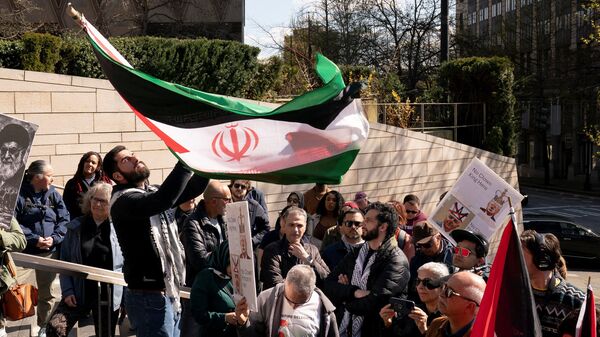 People gather for a 'No War on Iran' rally outside of City Hall in Seattle