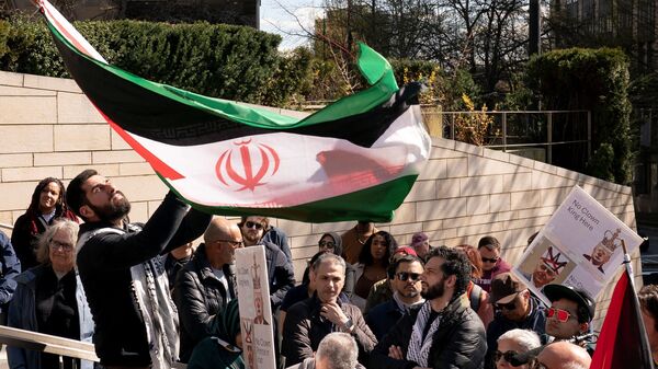 People gather for a 'No War on Iran' rally outside of City Hall in Seattle