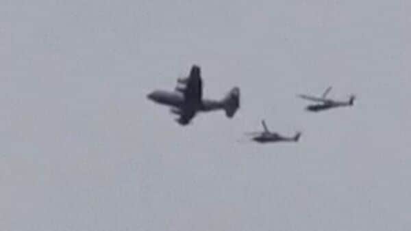 This video grab taken on April 3, 2026, from UGC images posted on social media on April 3, 2026 show a US aircraft, followed by two helicopters, flying over the town of Zaras in the southern Iran's Khuzestan province