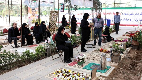 Iranians mourn at the graves of their loved ones killed during the US-Israeli war against the Islamic republic at the Behesht Zahra Cemetery in southern Tehran on April 23, 2026. (Photo by AFP) /