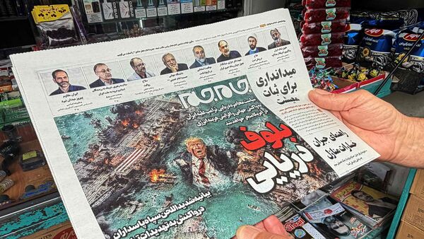 A man looks at the front page of the Jam Jam newspaper on sale at a newsstand, featuring a cartoon of US President Donald Trump drowning in the Strait of Hormuz with the headline 'Marine Bluff' in Tehran on April 13, 2026. The failure of US-Iran peace talks has left the US President with several unpalatable options, as analysts say his order to blockade the strategic Strait of Hormuz could further complicate his next move on April 12, 2026. Any hopes that US Vice President would emerge from the marathon day of negotiations with top Iranian officials with a deal to end a war that has rippled across the Middle East were dashed when he left hosts Pakistan emptyhanded. (Photo by ATTA KENARE / AFP) /