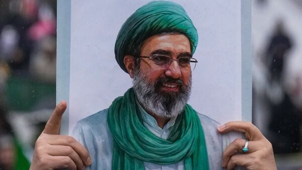 A woman holds up a poster of the Iranian Supreme Leader Ayatollah Mojtaba Khamenei during the annual anti-Israeli Quds Day, or Jerusalem Day, rally in support of Palestinians in Tehran, Iran, Friday, March 13, 2026. (AP Photo/Vahid Salemi)