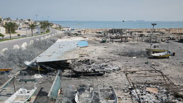 US-Israel-Iran War News Live Updates: Backdropped by ships in the Strait of Hormuz, damage, according to local witnesses caused by several recent airstrikes during the U.S.-Israel military campaign, is seen on a fishing pier in the port of Qeshm island, Iran, Monday, April 13, 2026. (AP Photo/Asghar Besharati)