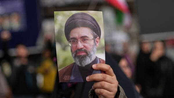 A demonstrator holds a picture of Iran's Supreme Leader Mojtaba Khamenei during a gathering after announcement of a two-week ceasefire with the United States and Israel, in Tehran, Iran, Wednesday, April 8, 2026. (AP Photo/Francisco Seco)