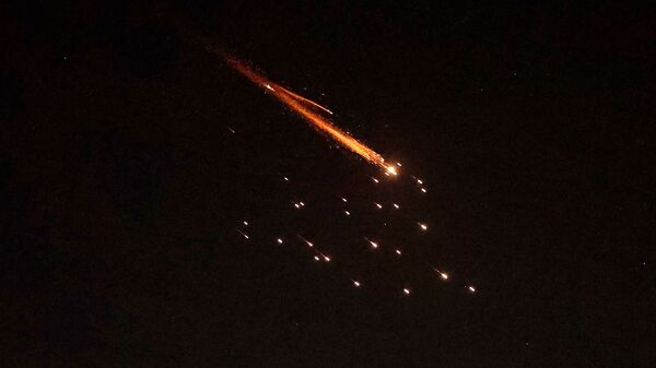 Rocket trails are seen in the sky amid a fresh barrage of Iranian missile attacks above the Israeli coastal city of Netanya on March 27, 2026. Israel warned its citizens to expect weeks more fighting against Iran, after Washington and Tehran traded threats to destroy power plants or block oil and gas exports. The tit-for-tat rhetoric came as the war that has seen drone and missile strikes across the Middle East, has sent energy prices soaring and has triggered fears for the world economy entered its fourth week. (Photo by JACK GUEZ / AFP)