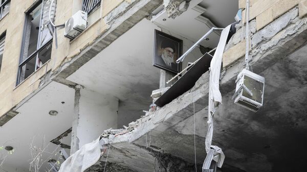 A portrait of Iran's slain supreme leader Ayatollah Ali Khamenei hangs on the wall of a damaged apartment during a media tour organised by Iran-backed militant group Hezbollah in the Haret Hreik area of Beirut's southern suburbs on April 20, 2026. Lebanon was drawn into the Middle East war on March 2 when Hezbollah launched attacks on Israel to avenge the killing of the Iranian leader. Israel has responded with broad strikes across Lebanon and a ground offensive