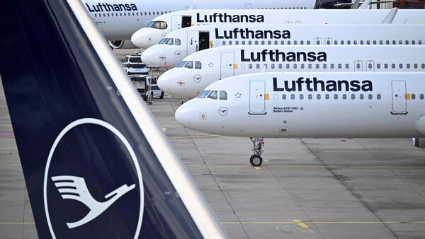 The logo of German airline Lufthansa is seen on the vertical stabiliser and aircraft parked on the tarmac at the international Frankfurt Airport, Frankfurt am Main, western Germany, on March 12, 2026.