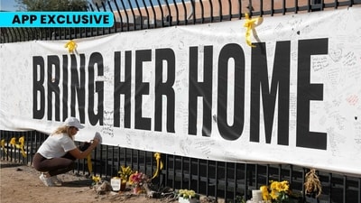 A visitor signs a banner for Nancy Guthrie that is displayed in front of the KVOA television station on March 01, 2026 in Tucson, Arizona. (AFP)