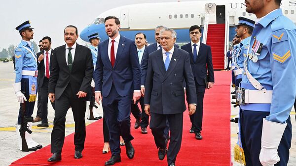 US Vice President JD Vance (C) walking with Pakistan Army Chief and Field Marshal Syed Asim Munir (2L) and Pakistan's Foreign Minister Ishaq Dar (2R) after arriving for the US-Iran peace talks in Islamabad.