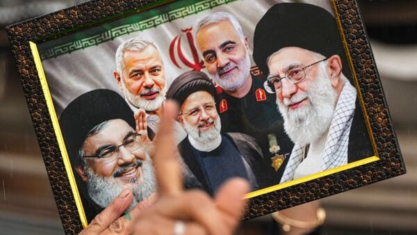 People raise slogans and hold a portrait of late Iran's Supreme Leader Ayatollah Ali Khamenei, in response to the ceasefire agreement between Iran, the United States and Israel, after US President Donald Trump pulled back from his threats to destroy Iranian civilization, in Srinagar, Jammu and Kashmir, Wednesday, April 8, 2026. (PTI Photo/S Irfan)(PTI04_08_2026_000197B)(PTI04_12_2026_000405B)