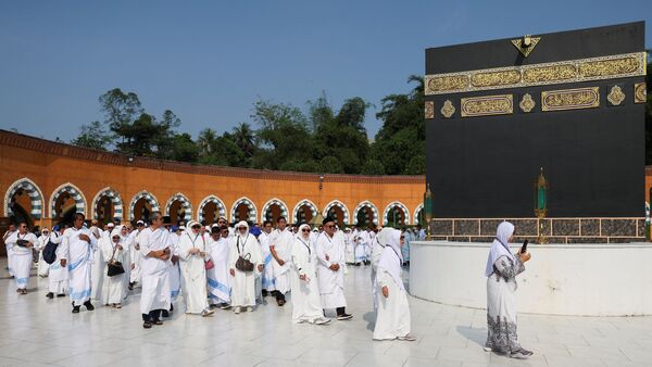 Indonesian muslims walk near a replica of the Kaaba as they perform Tawaf while practicing for the hajj pilgrimage at the Almahmudah Manasik Training Center, South Tangerang, on the outskirts of Jakarta, Indonesia, April 19, 2026. REUTERS/Ajeng Dinar Ulfiana