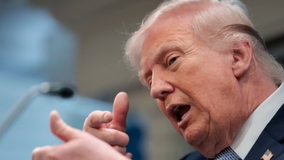 US President Donald Trump mimics firing a gun as he speaks about the conflict in Iran in the James S. Brady Press Briefing Room of the White House on April 6, 2026, in Washington, DC. (AFP)