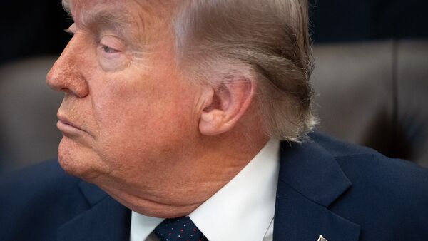 US President Donald Trump listens during an event on health care affordability in the Oval Office at the White House, Thursday, April 23, 2026, in Washington. (AP Photo/Mark Schiefelbein)