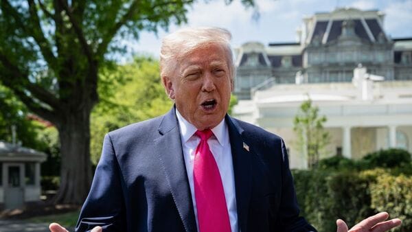 US President Donald Trump speaks to members of the media on the South Lawn of the White House before boarding Marine One in Washington, DC, US, on Thursday, April 16 (Image: Bloomberg)
