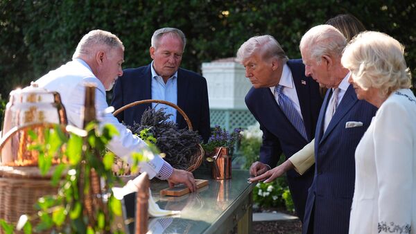 Britain's King Charles III and Queen Camilla join US President Donald Trump and First Lady Melania for a tour of the White House garden on the South Lawn of the White House in Washington, DC, on April 27, 2026. (Photo by Aaron Chown / POOL / AFP)