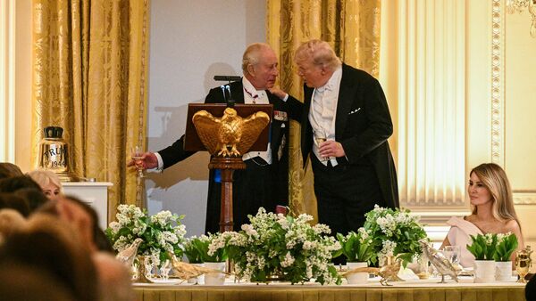 King Charles III presenting World War II-era bell with the inscription 'Trump 1944' as a gift to US President Donald Trump during White House State Dinner in Washington DC on 28 April 2026.