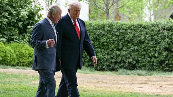 US President Donald Trump walks with Britain's King Charles III after their meeting in the Oval Office of the White House in Washington, DC, on April 28, 2026. (Photo by Jim WATSON / AFP)