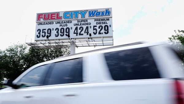 A driver makes their way past a billboard by the entrance at Fuel City filling station that reflects the current gasoline prices Friday, April 17, 2026, in Dallas.