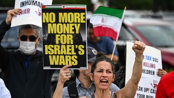 Protestors rally against US military action in Iran during a demonstration in Houston, Texas, on April 7, 2026. US President Donald Trump warned that 'a whole civilization will die' in Iran if the country does not heed his midnight cutoff to open the Strait of Hormuz, as Tehran reported US-Israeli attacks on its infrastructure were already underway. (Photo by RONALDO SCHEMIDT / AFP)