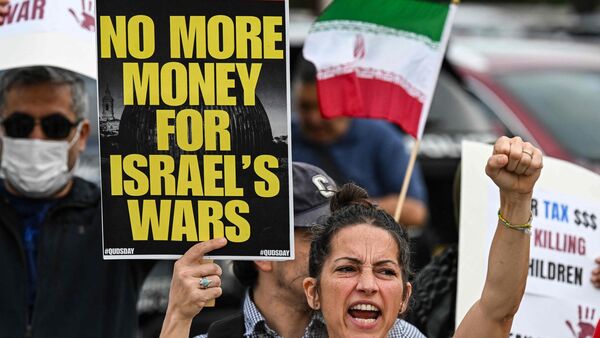 Protestors rally against US military action in Iran during a demonstration in Houston, Texas, on April 7, 2026. US President Donald Trump warned that 'a whole civilization will die' in Iran if the country does not heed his midnight cutoff to open the Strait of Hormuz, as Tehran reported US-Israeli attacks on its infrastructure were already underway.