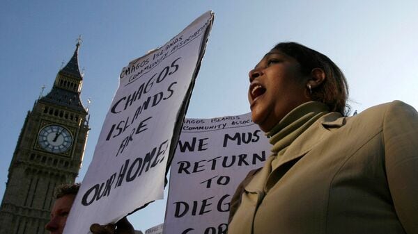 FILE PHOTO: A demonstrator demanding her return to the Chagos Islands in the Diego Garcia archipelago shouts during a protest outside the Houses of Parliament in London October 22, 2008./File Photo
