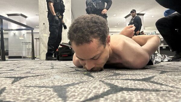 Law enforcement personnel detain Cole Tomas Allen, a suspect in the shooting incident at the White House Correspondents' Association dinner, in Washington, D.C., U.S. April 25, 2026.