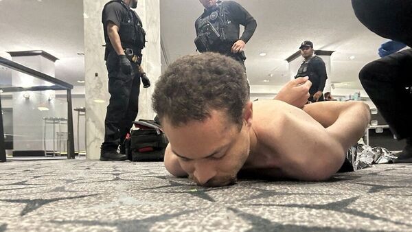 Law enforcement personnel detain Cole Tomas Allen, a suspect in the shooting incident at the White House Correspondents' Association dinner, in Washington, D.C., U.S. April 25, 2026.