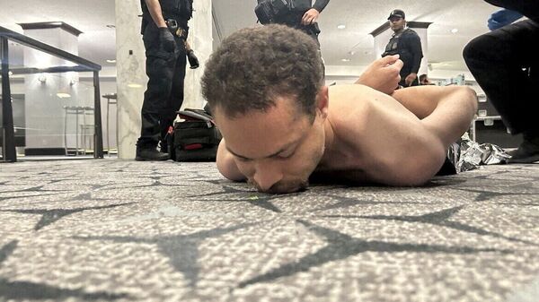 Law enforcement personnel detain Cole Tomas Allen, a suspect in the shooting incident at the White House Correspondents' Association dinner, in Washington, D.C., U.S. April 25, 2026
