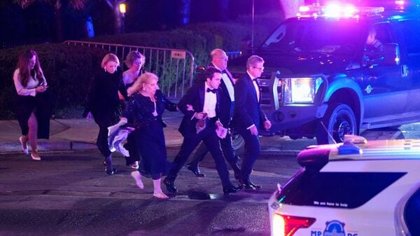 Attendees leave the venue as a shooter opens fire during the annual White House Correspondents' Association dinner in Washington, D.C., U.S., April 25, 2026. REUTERS/Ken Cedeno