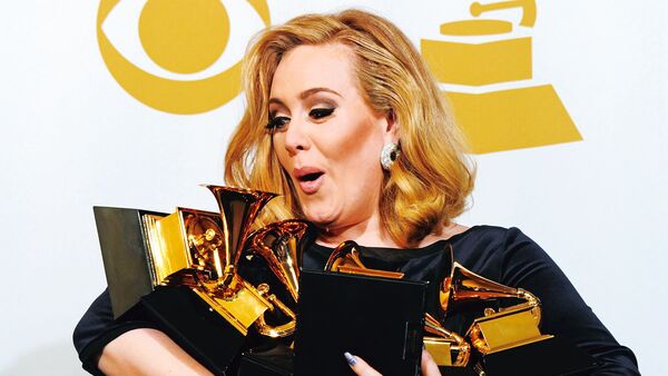 Musician Adele poses with her six trophies at the 54th Grammy Awards in Los Angeles, California, February 12, 2012. TOPSHOTS AFP PHOTO/ FREDERIC J. BROWN