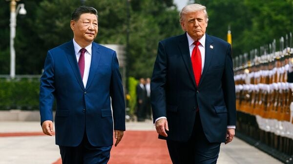 US President Donald Trump receives the guard of honour, at Great Hall of the People, in Beijing on Thursday. Chinese President Xi Jinping also present. (@WhiteHouse X/ANI Photo)