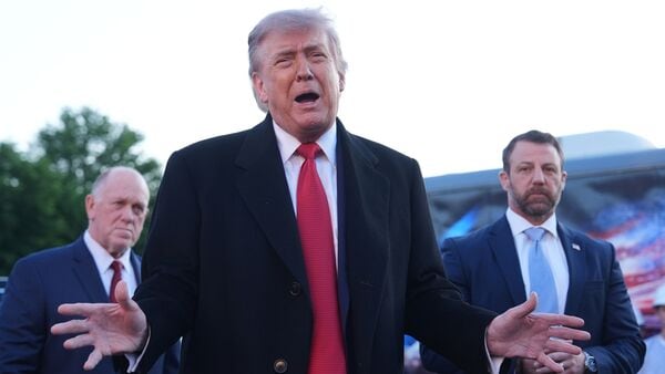 President Donald Trump speaks as he visits the Lincoln Memorial Reflecting Pool to see the new blue protective coating being applied as part of a renovation project, Thursday, May 7, 2026, in Washington, as White House boarder czar Tom Homan and Homeland Security Secretary Markwayne Mullin listen. AP/PTI(AP05_08_2026_000030A)