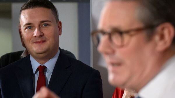 FILE PHOTO: Britain's Secretary of State for Health and Social Care, Wes Streeting, looks on as Prime Minister Keir Starmer