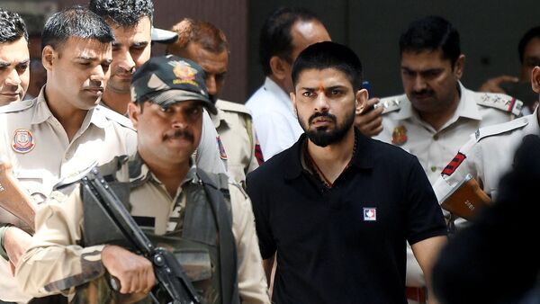 File photo: Policemen escort Lawrence Bishnoi at a court in New Delhi in 2023.