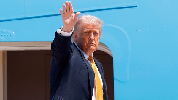 President Donald Trump waves from the stairs of Air Force One as he boards upon his arrival at Joint Base Andrews, Md., Tuesday, May 12, 2026, for a trip to China to meet President Xi Jinping. (AP Photo/Luis M. Alvarez)