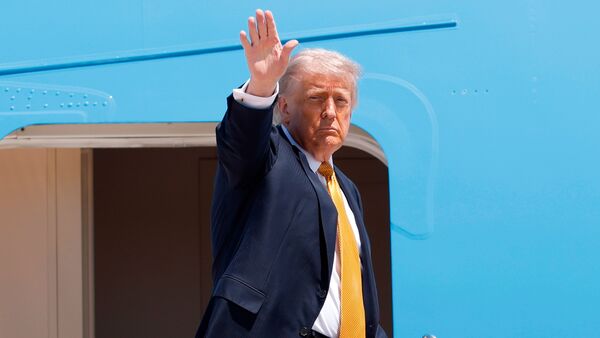 President Donald Trump waves from the stairs of Air Force One as he boards upon his arrival at Joint Base Andrews, Md., Tuesday, May 12, 2026, for a trip to China to meet President Xi Jinping