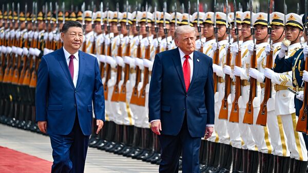 President Donald Trump reviews troops with China's President Xi Jinping at the Great Hall of the People, Thursday, May 14, 2026, in Beijing. (Kenny Holston/The New York Times via AP, Pool)