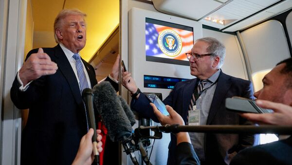 US President Donald Trump briefing the press aboard Air Force One before departing from Beijing following his official visit with President Xi Jinping in China on May 15.